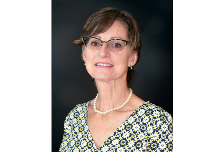 A woman wearing glasses and a necklace